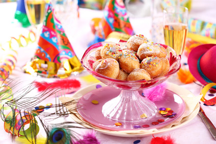 Carnival and party place setting with small berliners (fried doughnut)